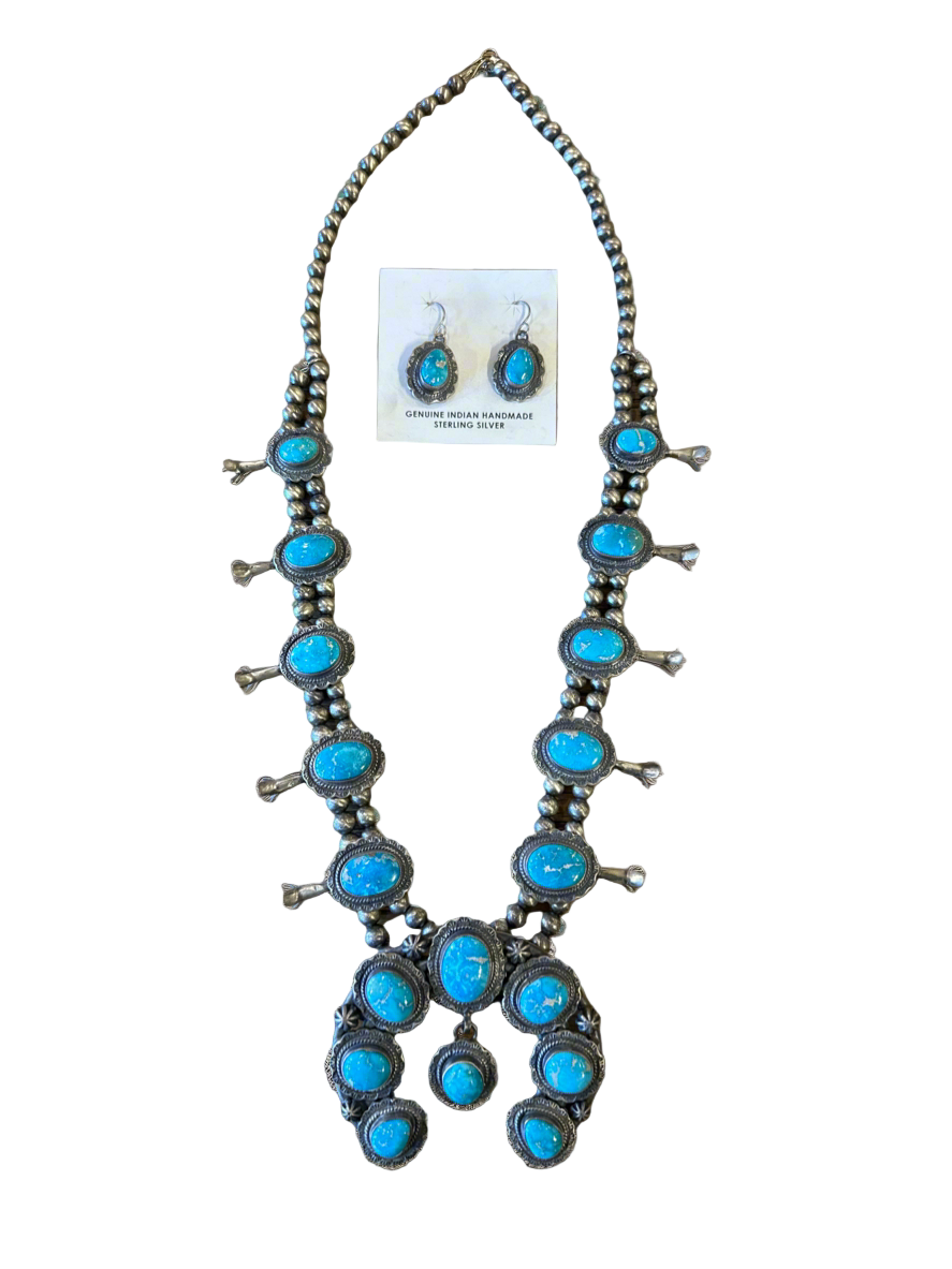 Turquoise necklace with matching earrings on a gray background
