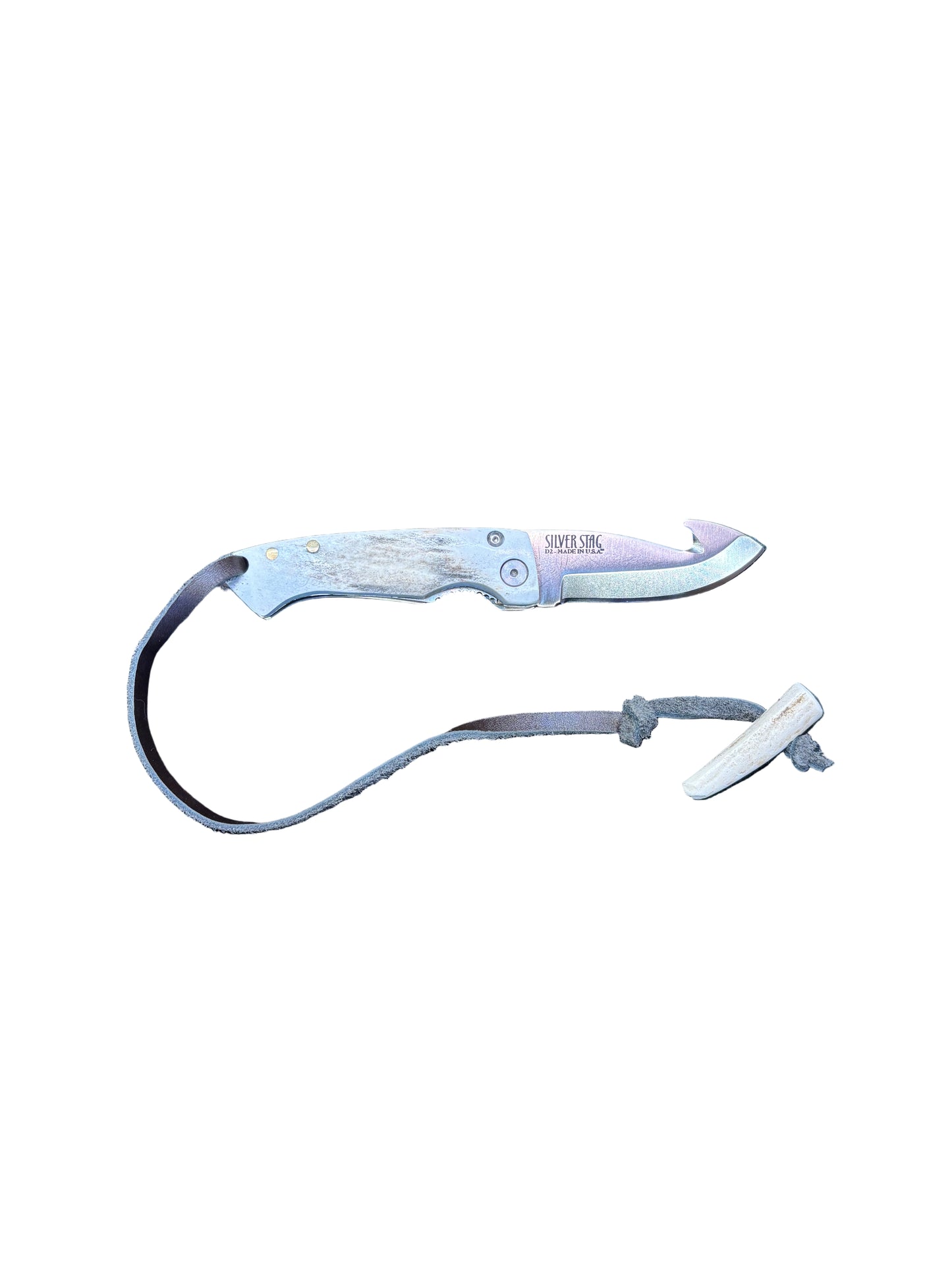 Folding knife with a lanyard on a textured surface
