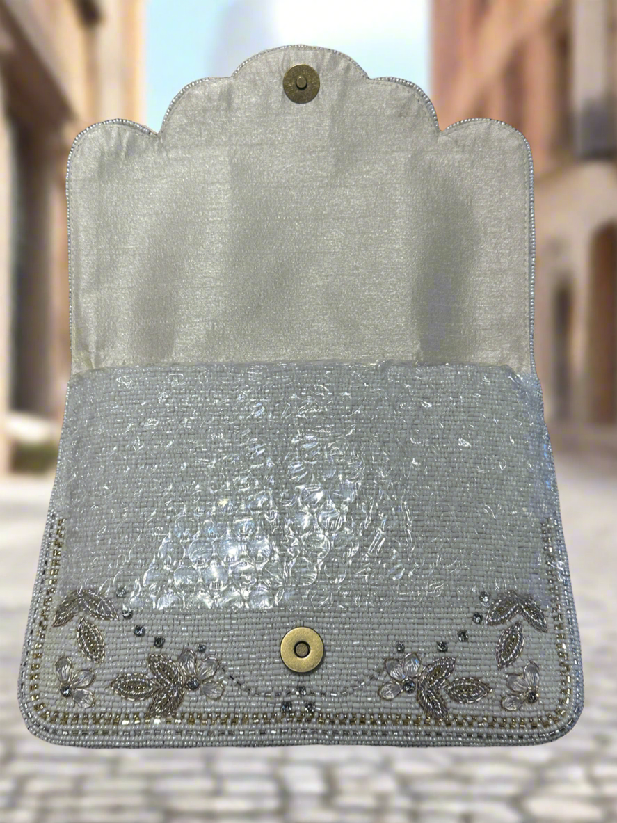 Decorative clutch bag with intricate patterns on a white background