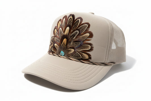 Beige cap with feather embellishments on a white background