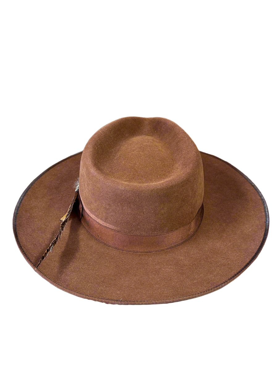Brown cowboy hat with a wide brim on a white background