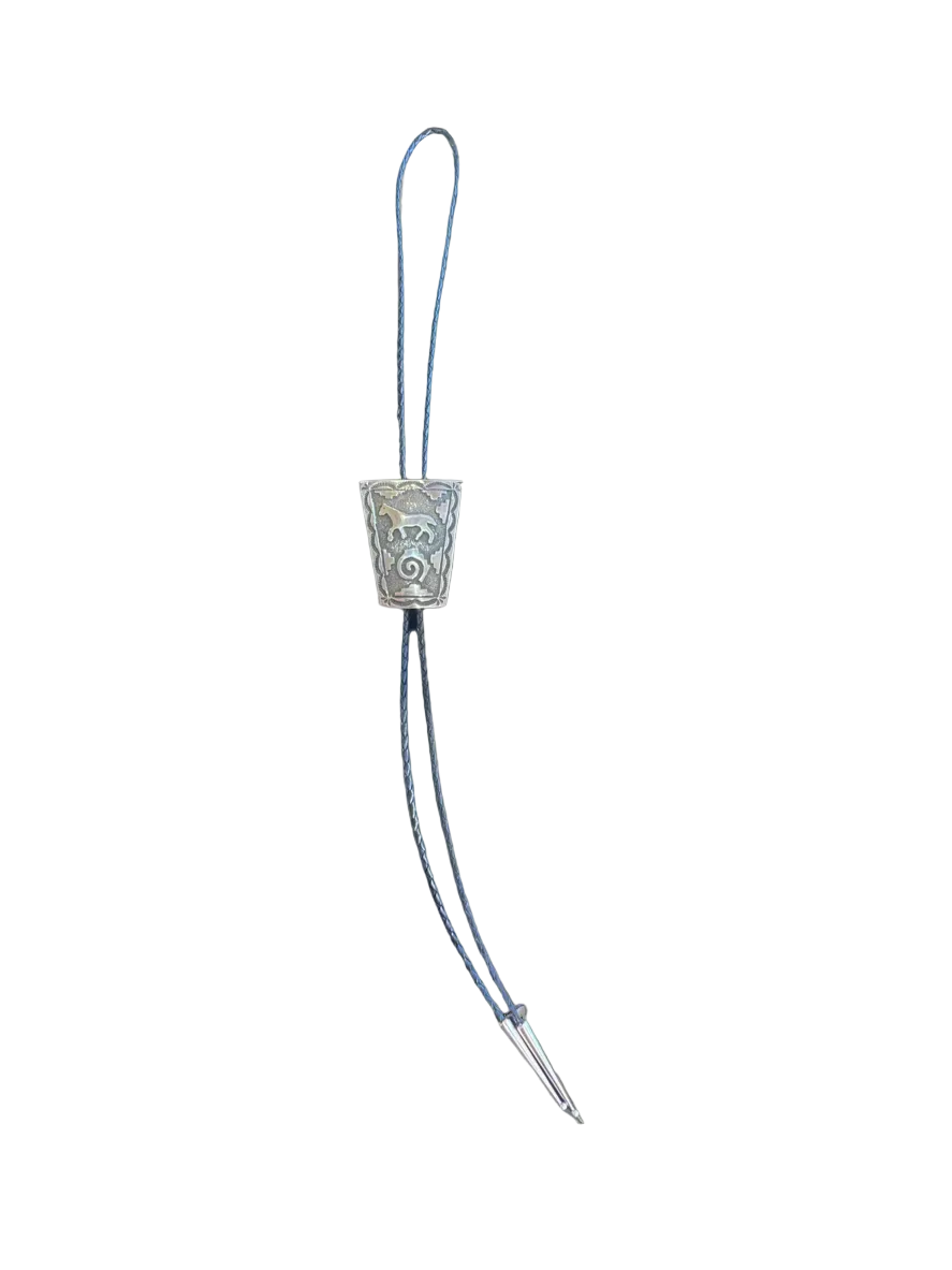 Decorative metal object with a string on a white background