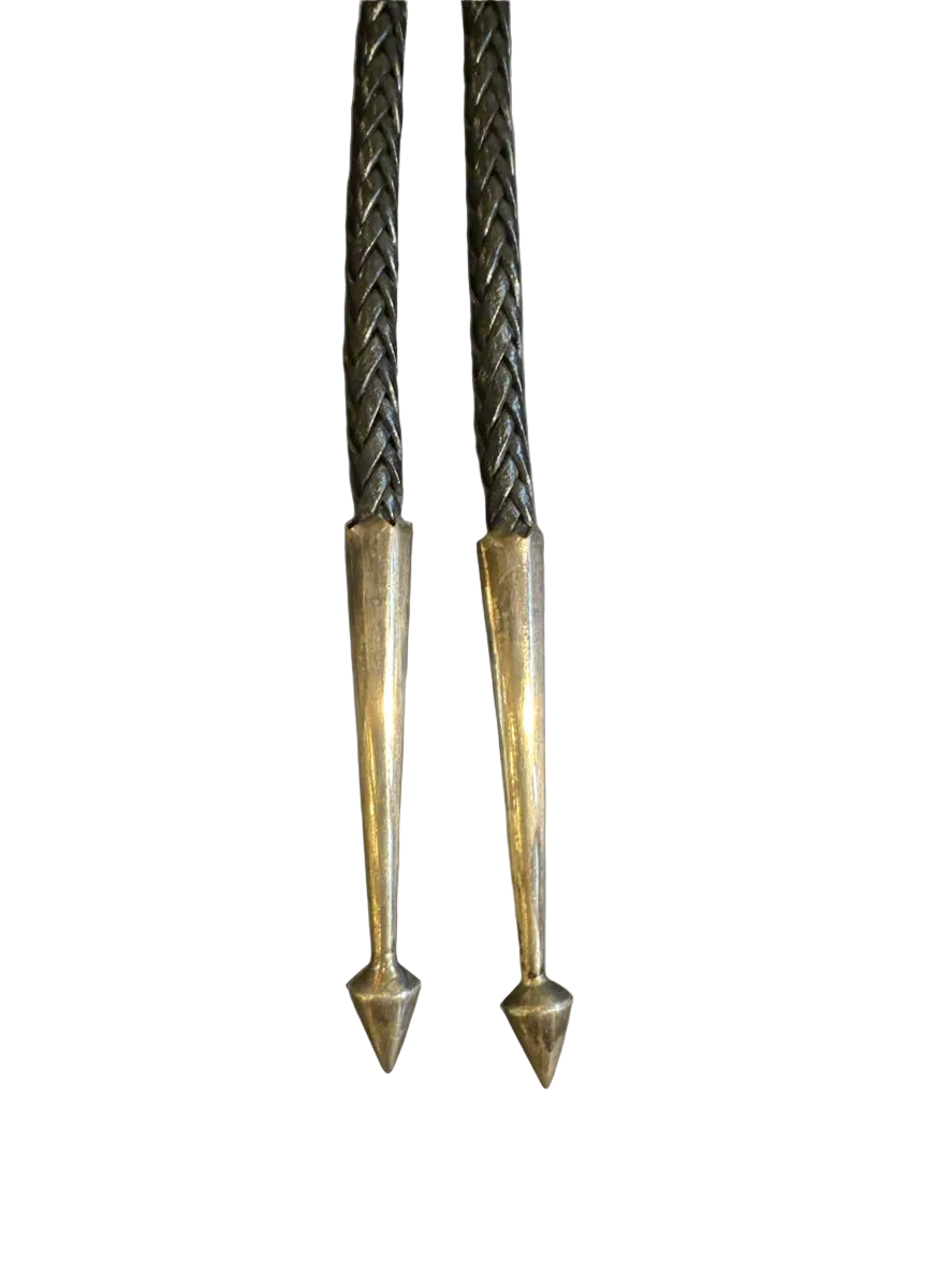 Two metal stakes with pointed ends on a white background