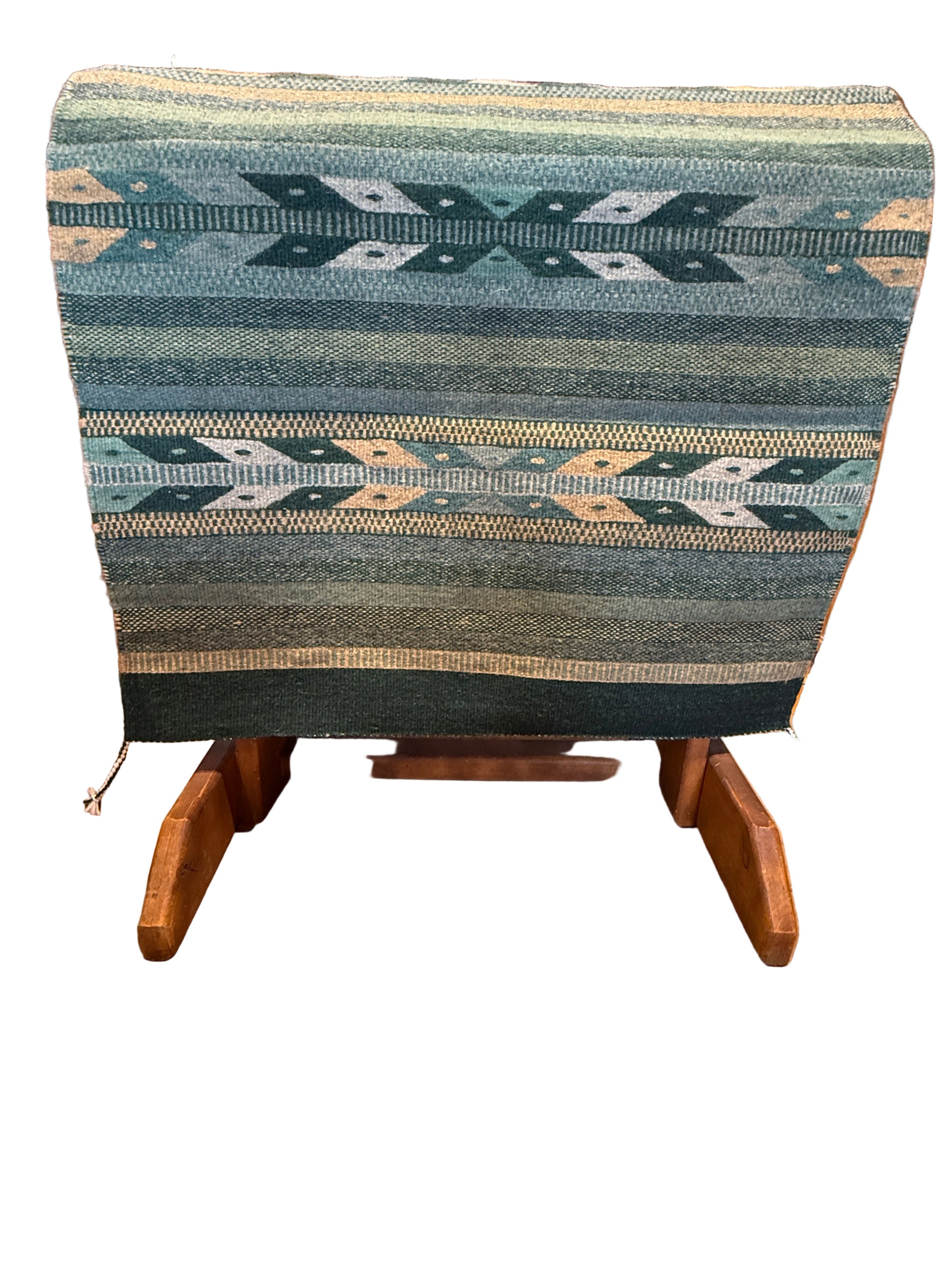 Textile with geometric pattern draped over a wooden chair