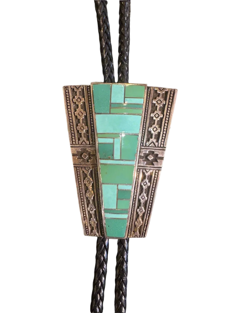 Bolo tie with mosaic green design on a white background
