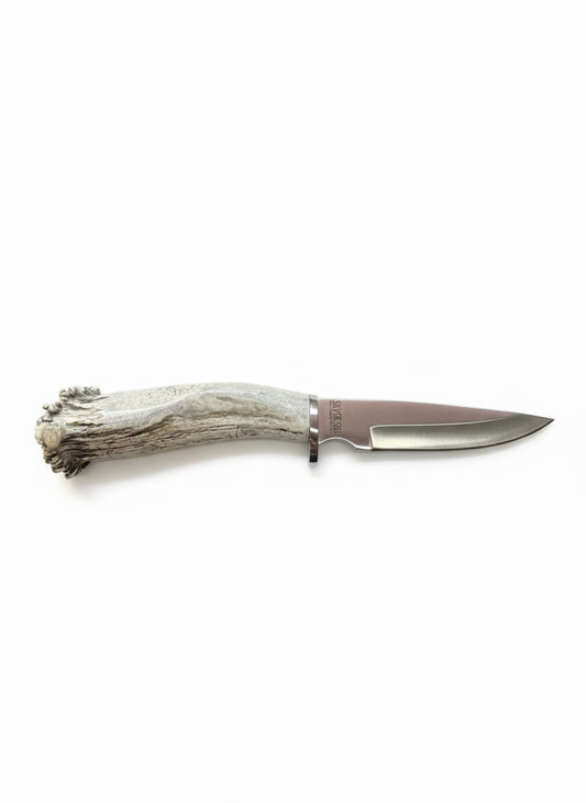 Knife with deer antler handle on a white background