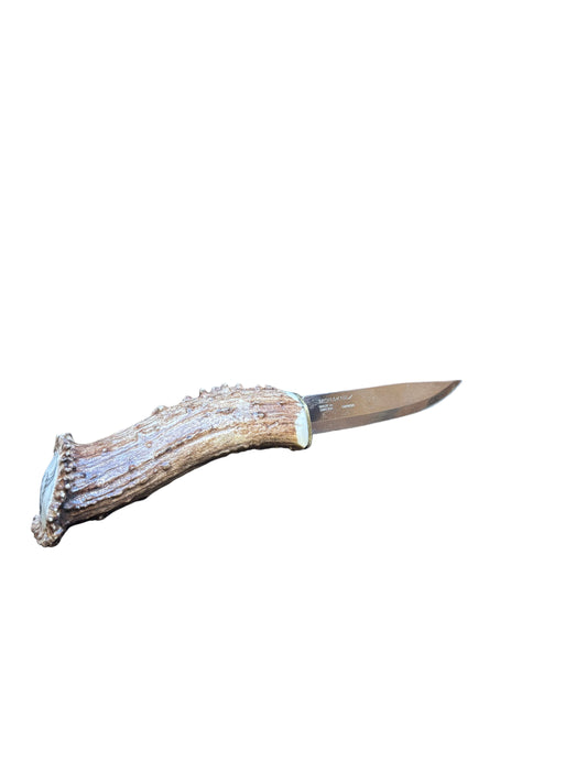 Knife with a decorative handle on a dark surface