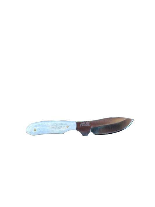 Knife with a white handle on a textured black surface