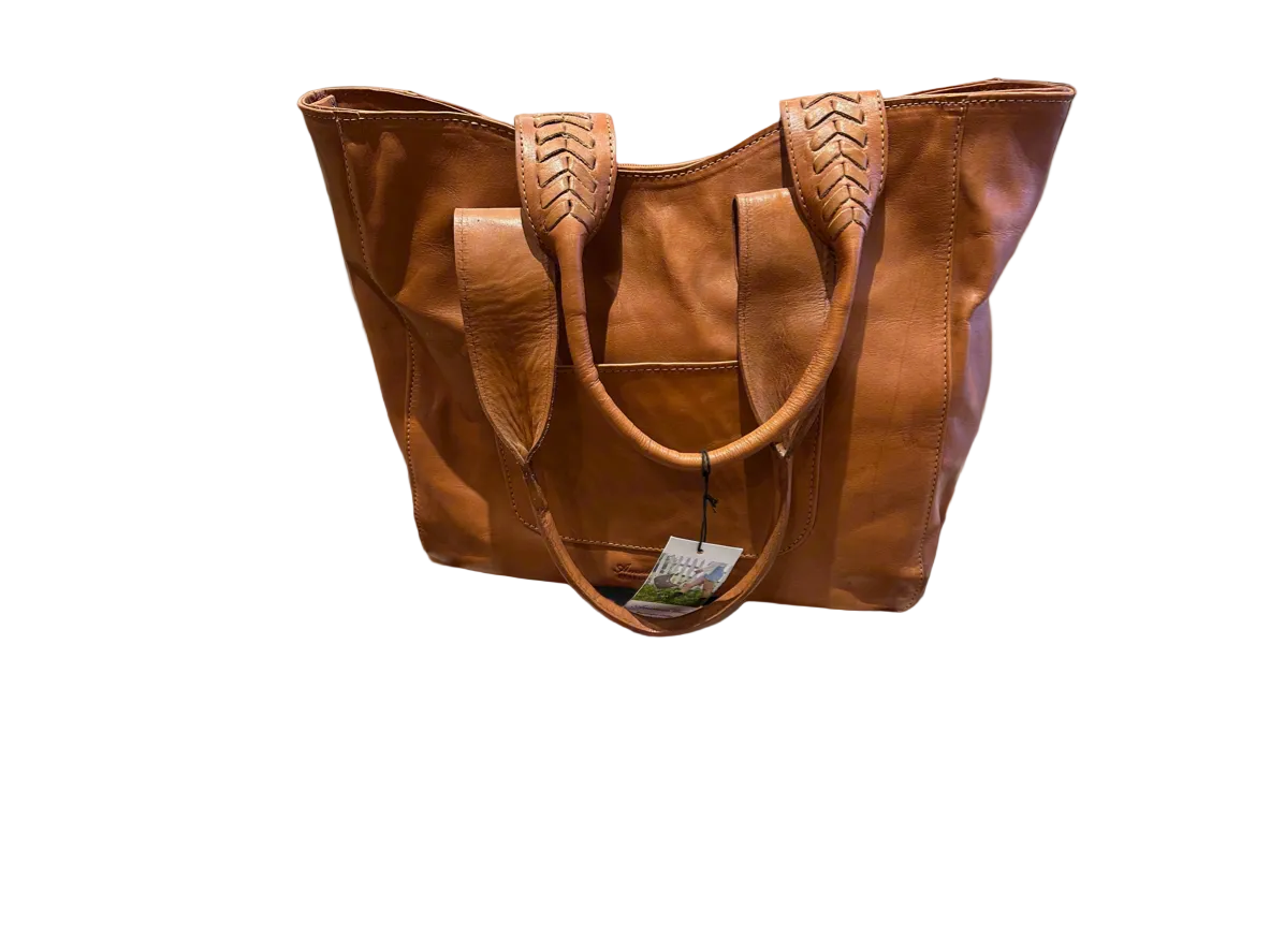 Brown leather tote bag with decorative handles on a white background