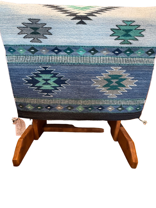 Blue patterned blanket draped over a wooden chair