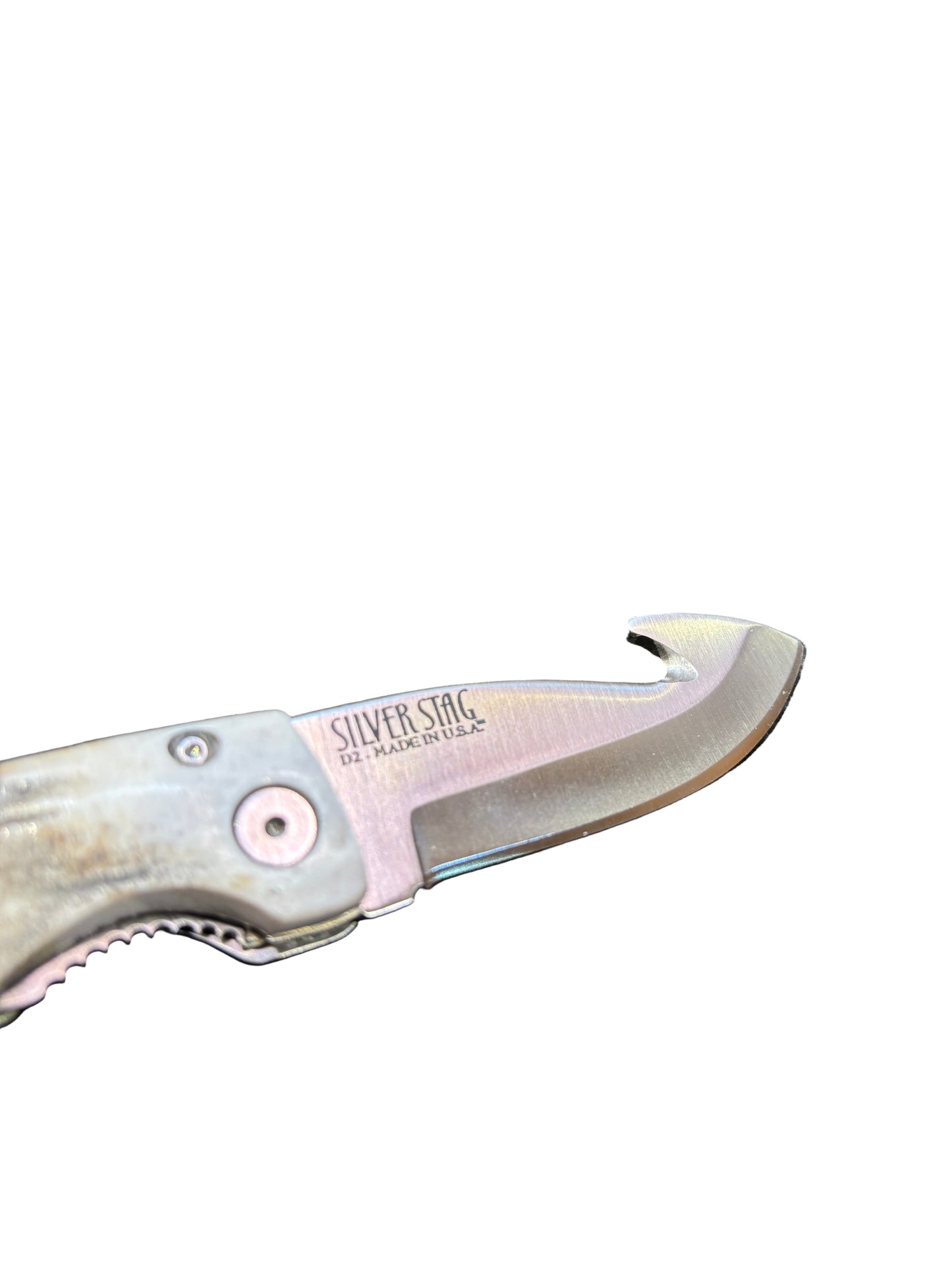 Folding knife with a visible brand name on a textured surface