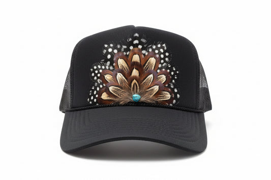 Black trucker cap with decorative peacock feather design on a white background