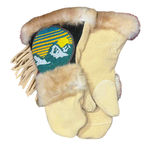 Pair of yellow mittens with fur trim and a decorative patch on a neutral background