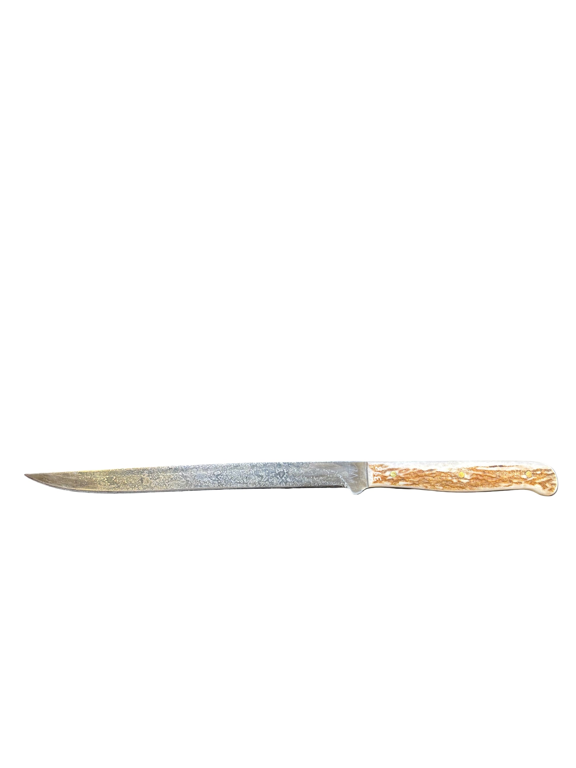 Knife with wooden handle on a dark gray cushion inside a wooden box.