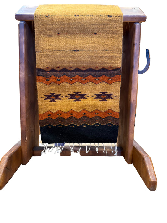 Wooden stool with a patterned seat cover in a rustic setting