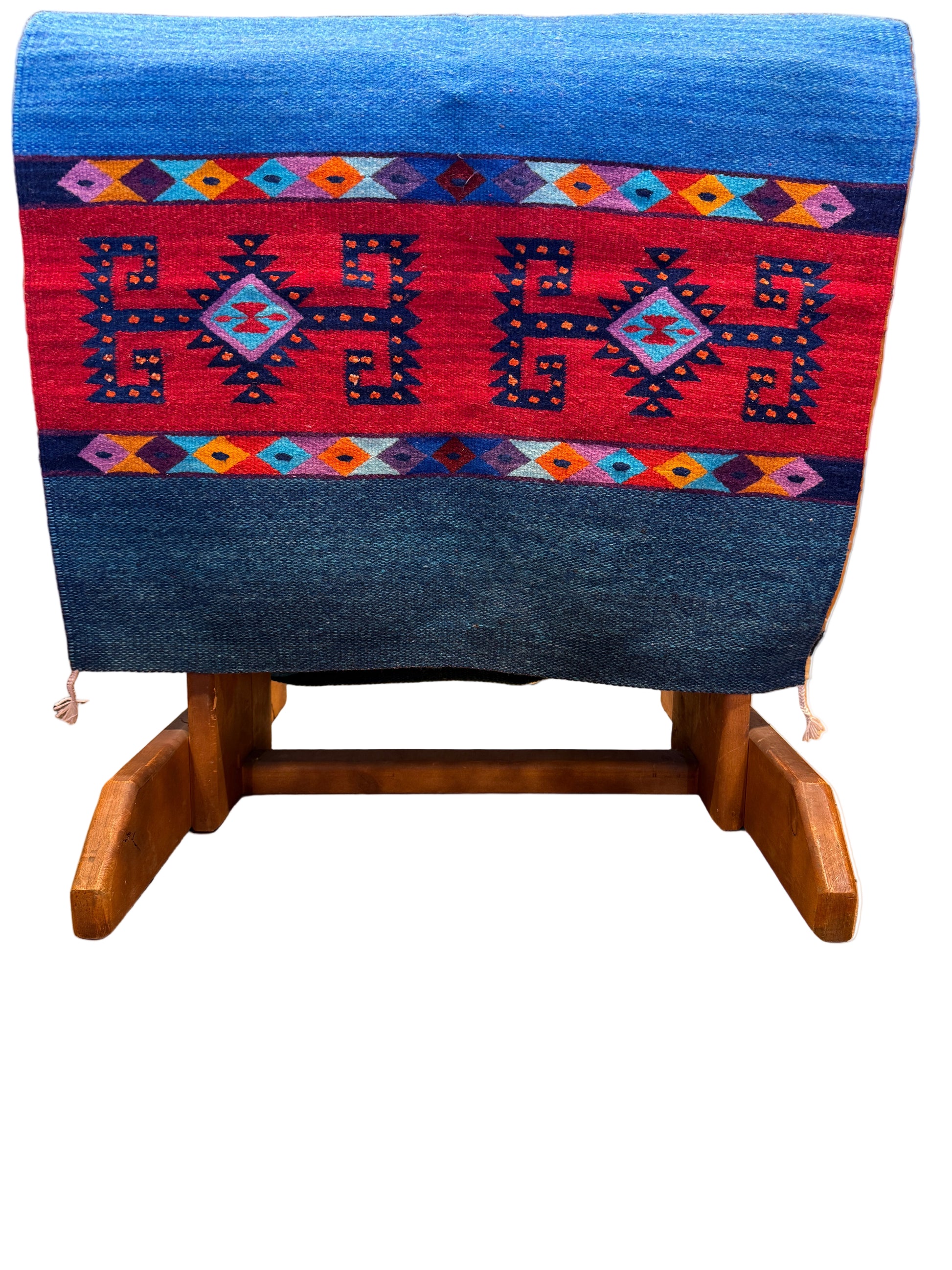 Woven textile with geometric patterns on a wooden loom