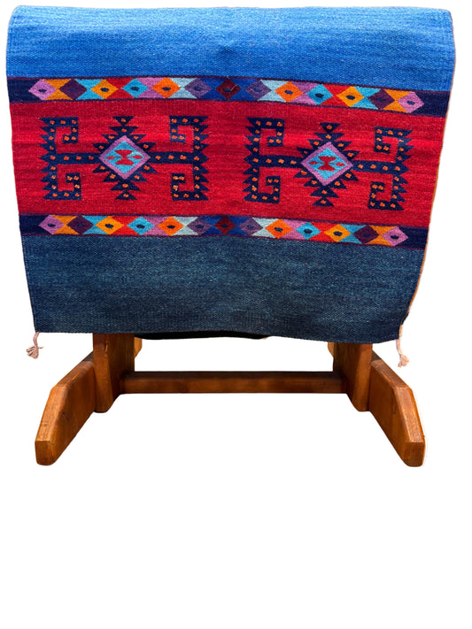 Woven textile with geometric patterns on a wooden loom