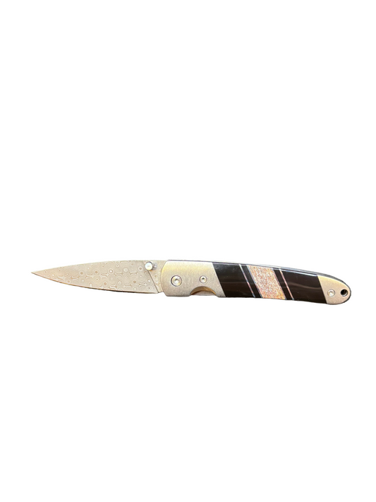 Folding knife with a decorative handle on a white background