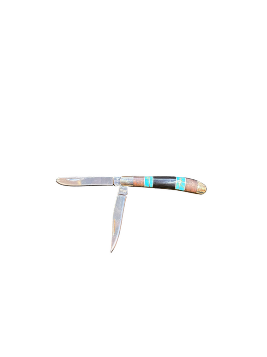 Foldable pocket knife with decorative handle on a white background