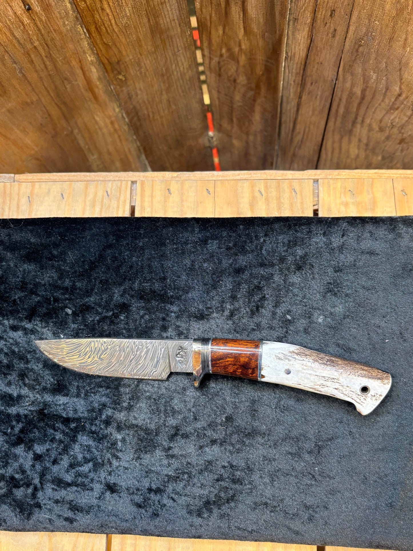 Knife with wooden handle on a dark surface, wooden background