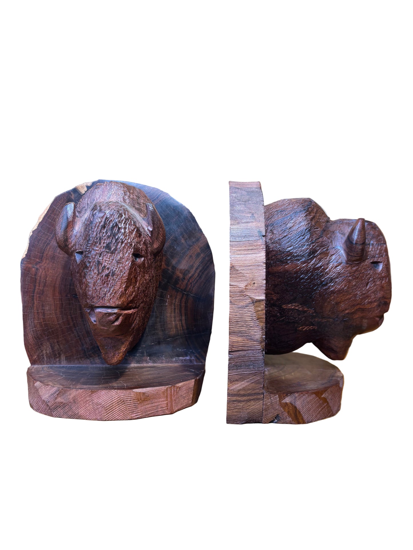 Two wooden bear figurines on a wooden surface with a blurred background