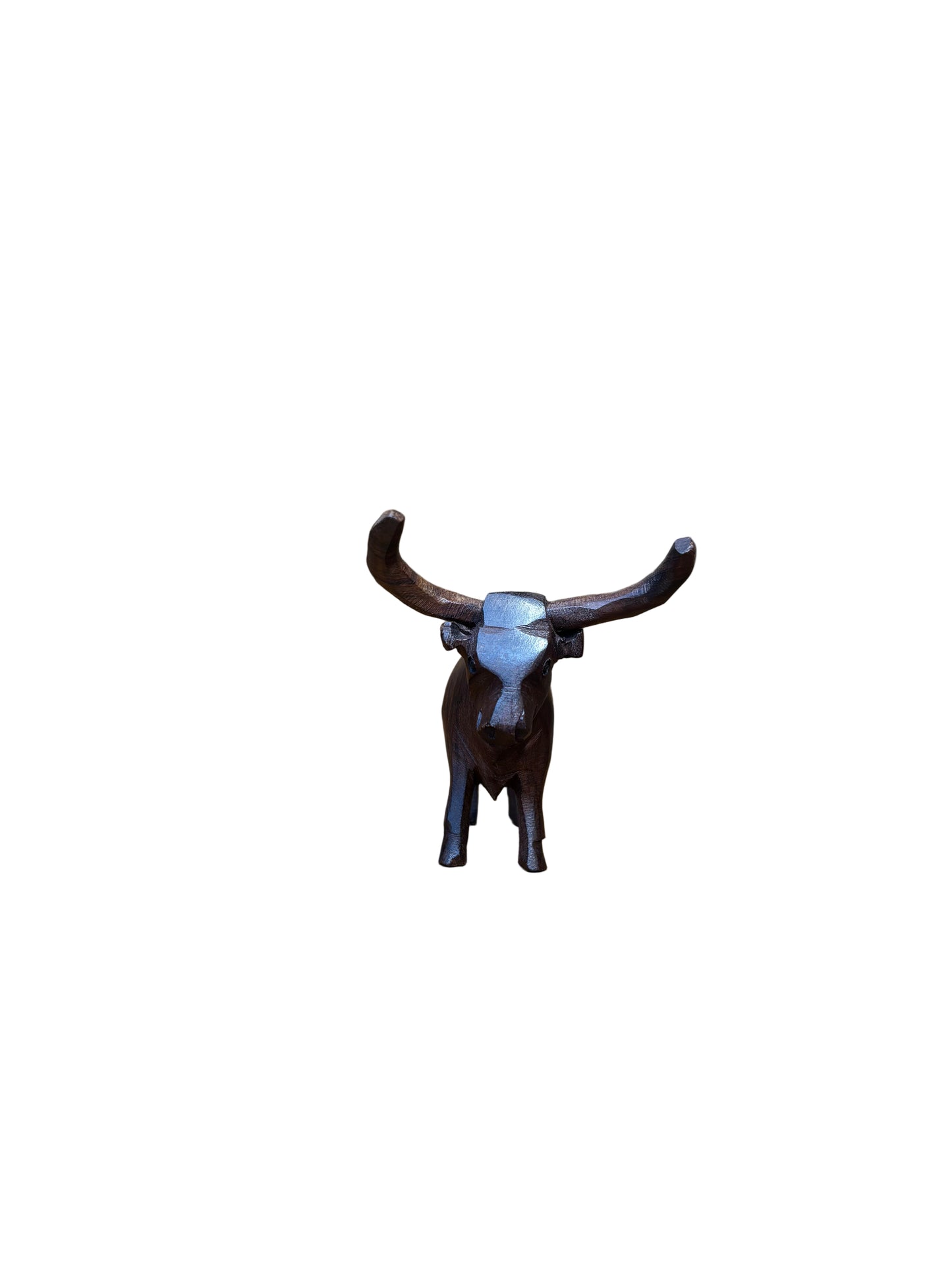 Small deer figurine on a wooden stand against a wooden background