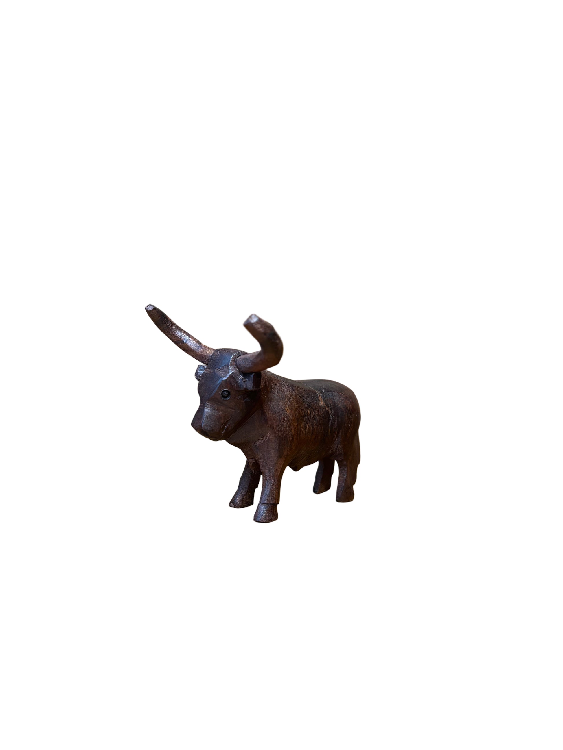 Decorative metal dog hook on a wooden surface