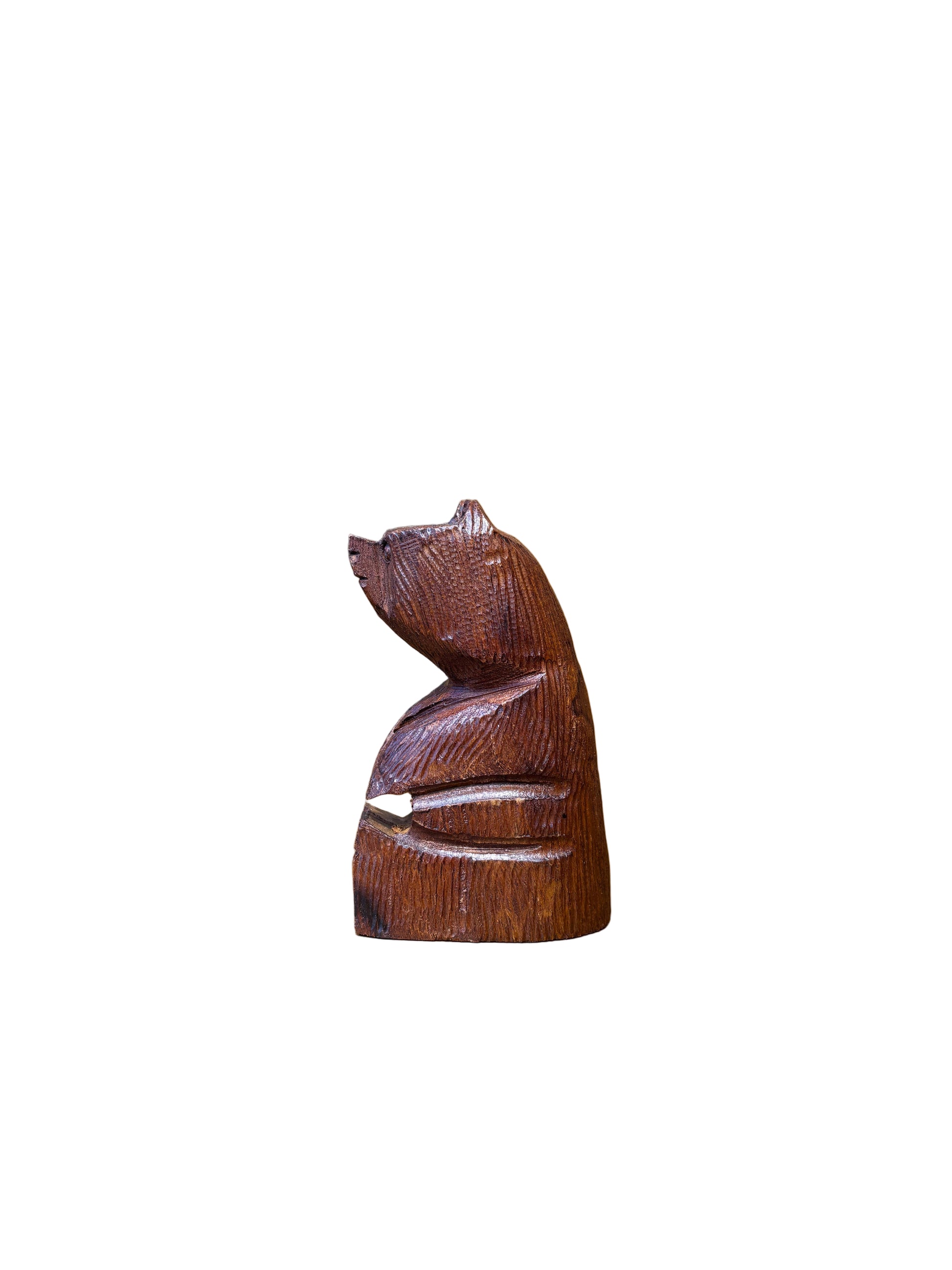 Wooden handle with intricate carvings on a wooden surface
