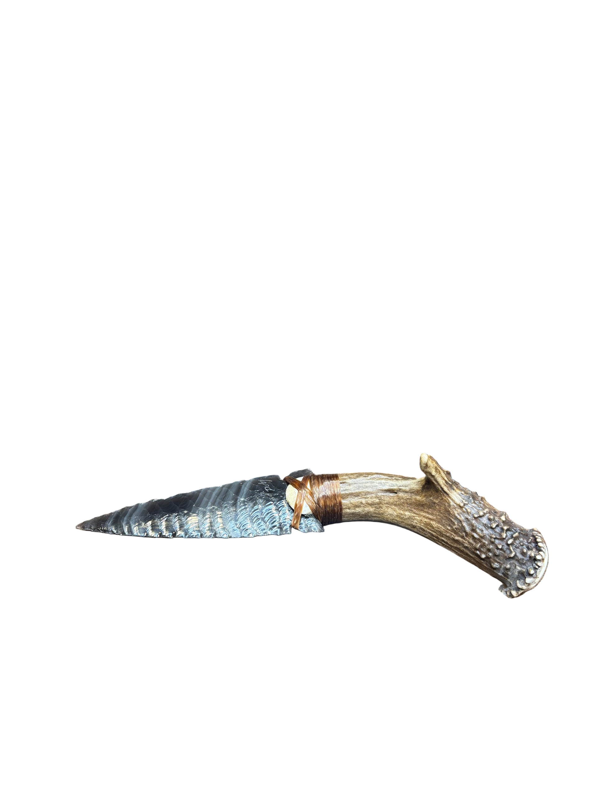 Decorative rug with a deer antler on a wooden surface