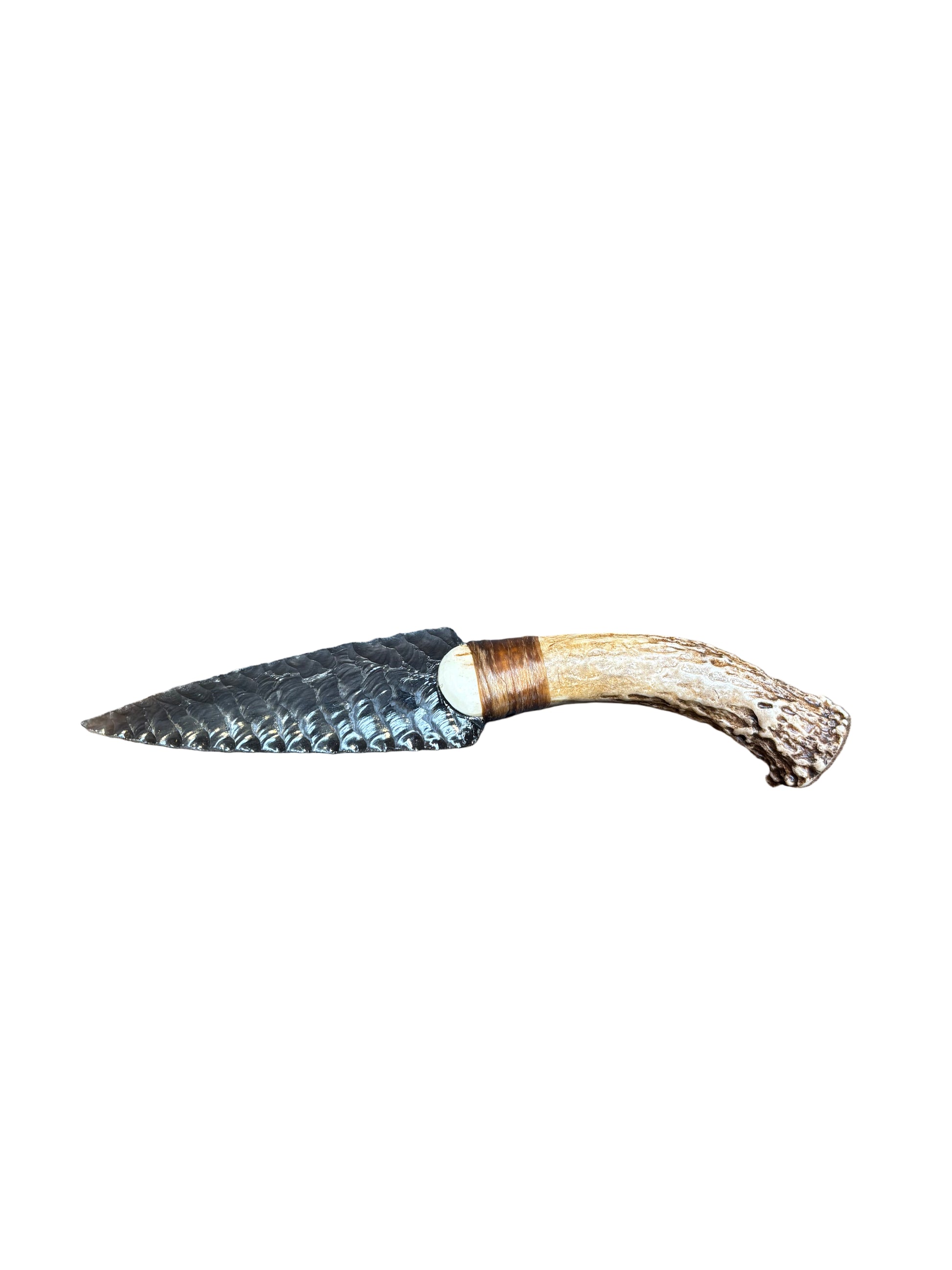 Decorative knife with antler handle on a patterned rug