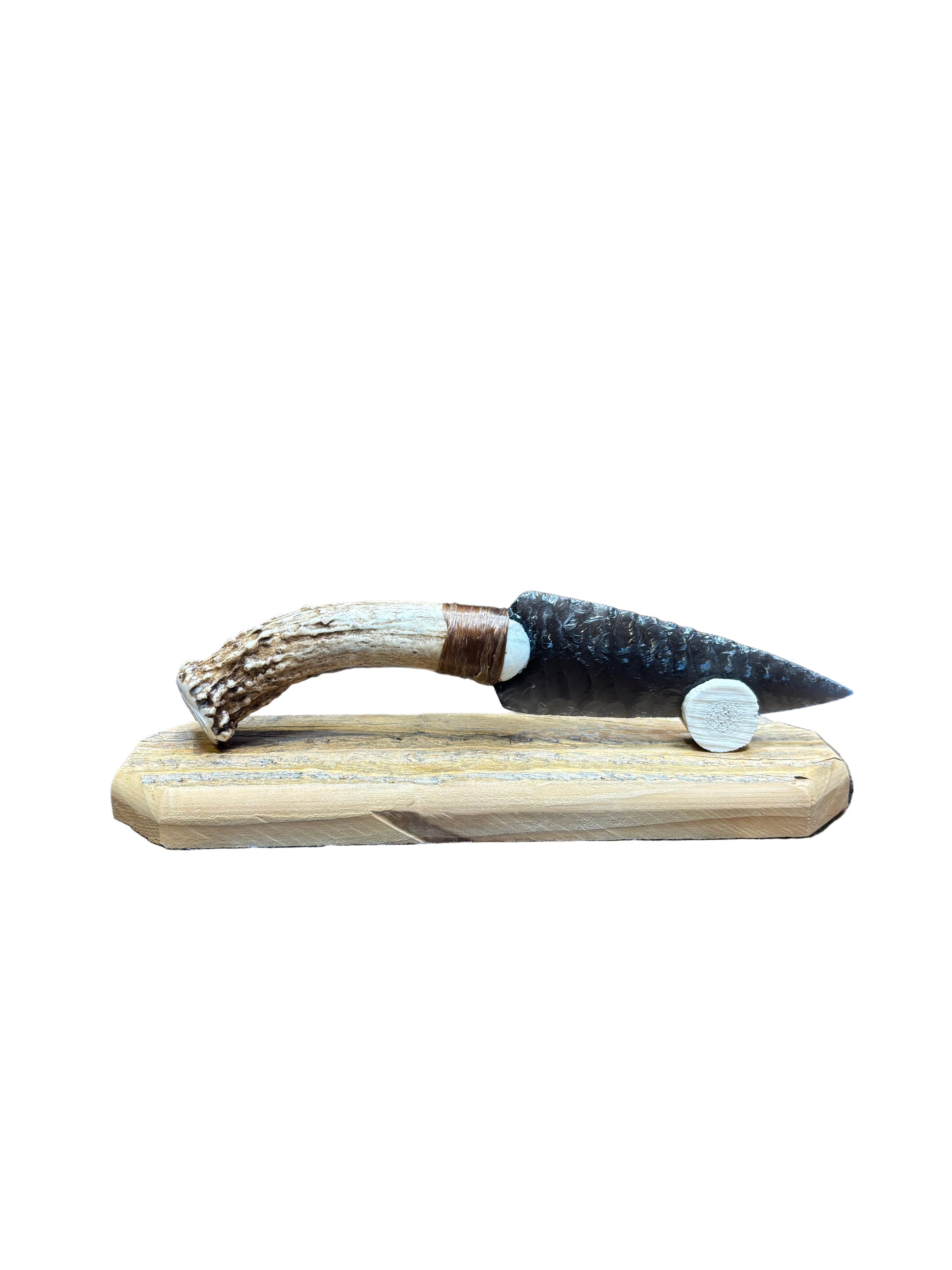 Wooden handle with antler design on a textured surface