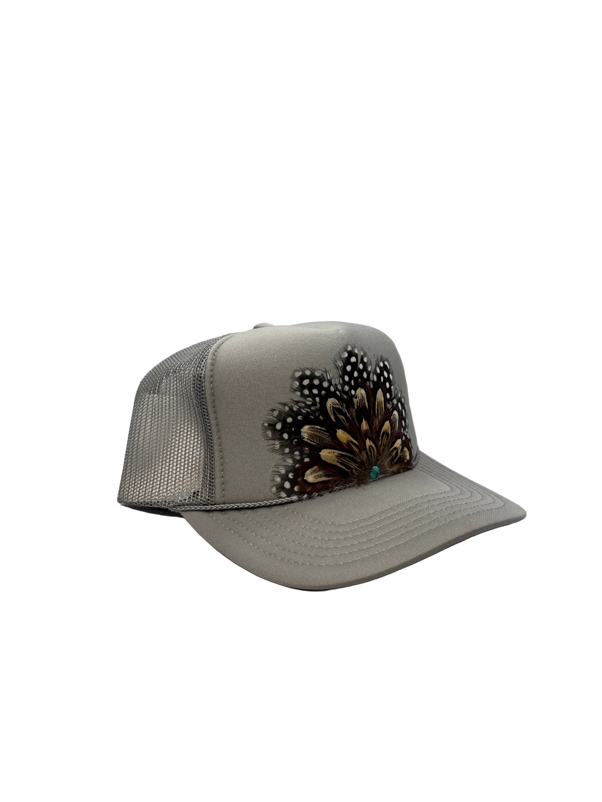 Gray visor with decorative feathers on a white background