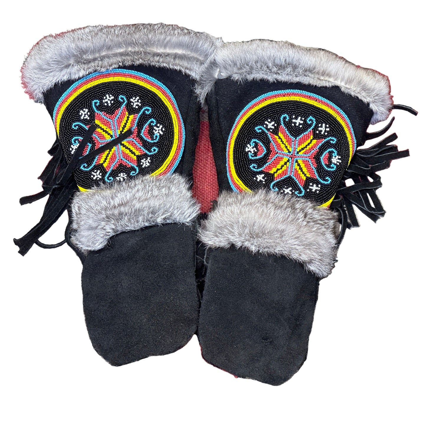 Pair of black mittens with colorful beadwork on a patterned rug